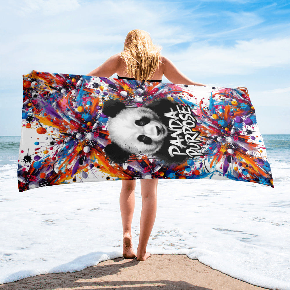 Woman Holding a Colorful "Panda Purpose" Beach Towel with Abstract Design on the Beach – Showcasing Unique and Artistic Beach Accessories for Women, Featuring Vibrant Graphics and Inspirational Panda Art for a Stylish Beach Day