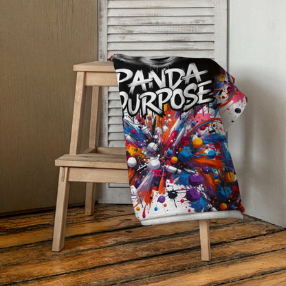 Vibrant Beach Towel with "Panda Purpose" Text and Colorful Abstract Design Draped Over a Wooden Chair – Showcasing Artistic and Inspirational Beach Accessories with Bold Graphics, Perfect for Adding a Splash of Color to Any Space